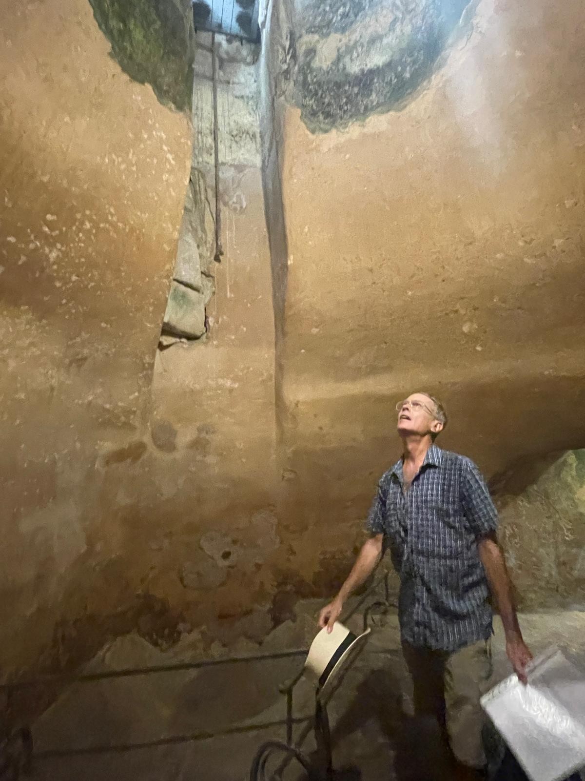 Jeremy looking up inside an ancient stone passage